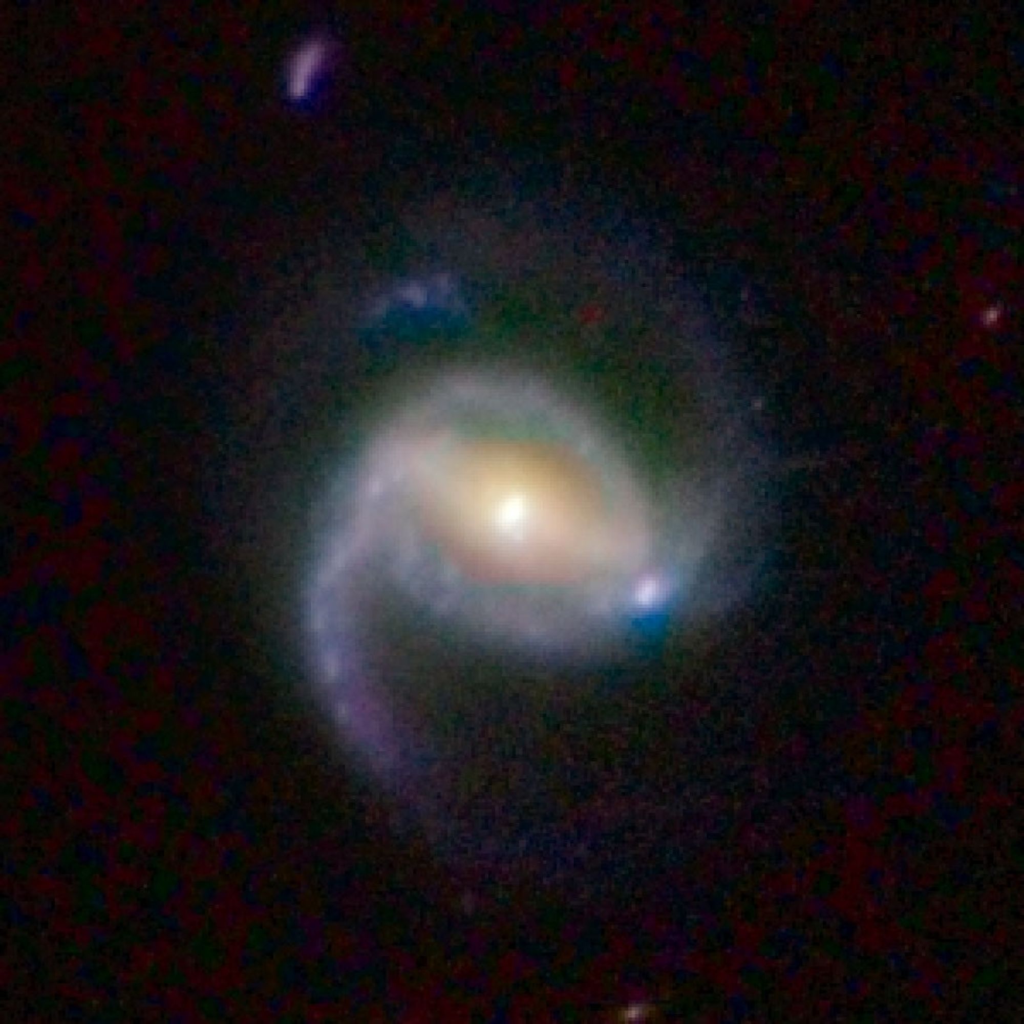 A galaxy, which appears as a misshapen circle, is in the center against a black background.