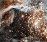 Framed image of a dense cluster of bright yellow-white stars surrounded by fluffy brown and white material. Title text at top reads “30 Doradus in the Large Magellanic Cloud.”