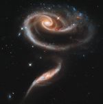 Two spiral galaxies forming a rose-like pattern.