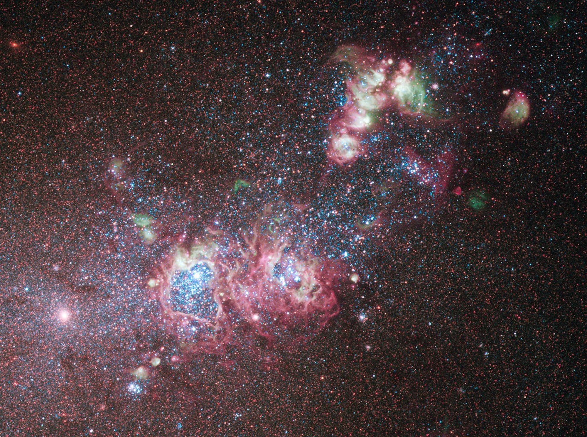 Several gas clouds stretch diagonally across the image, with two large, roughly circular cavities in the gas.