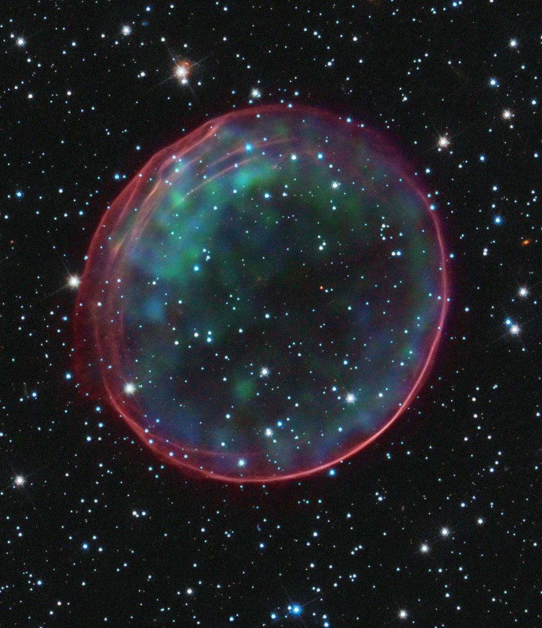 Colorful supernova remnant resembling a soap bubble.