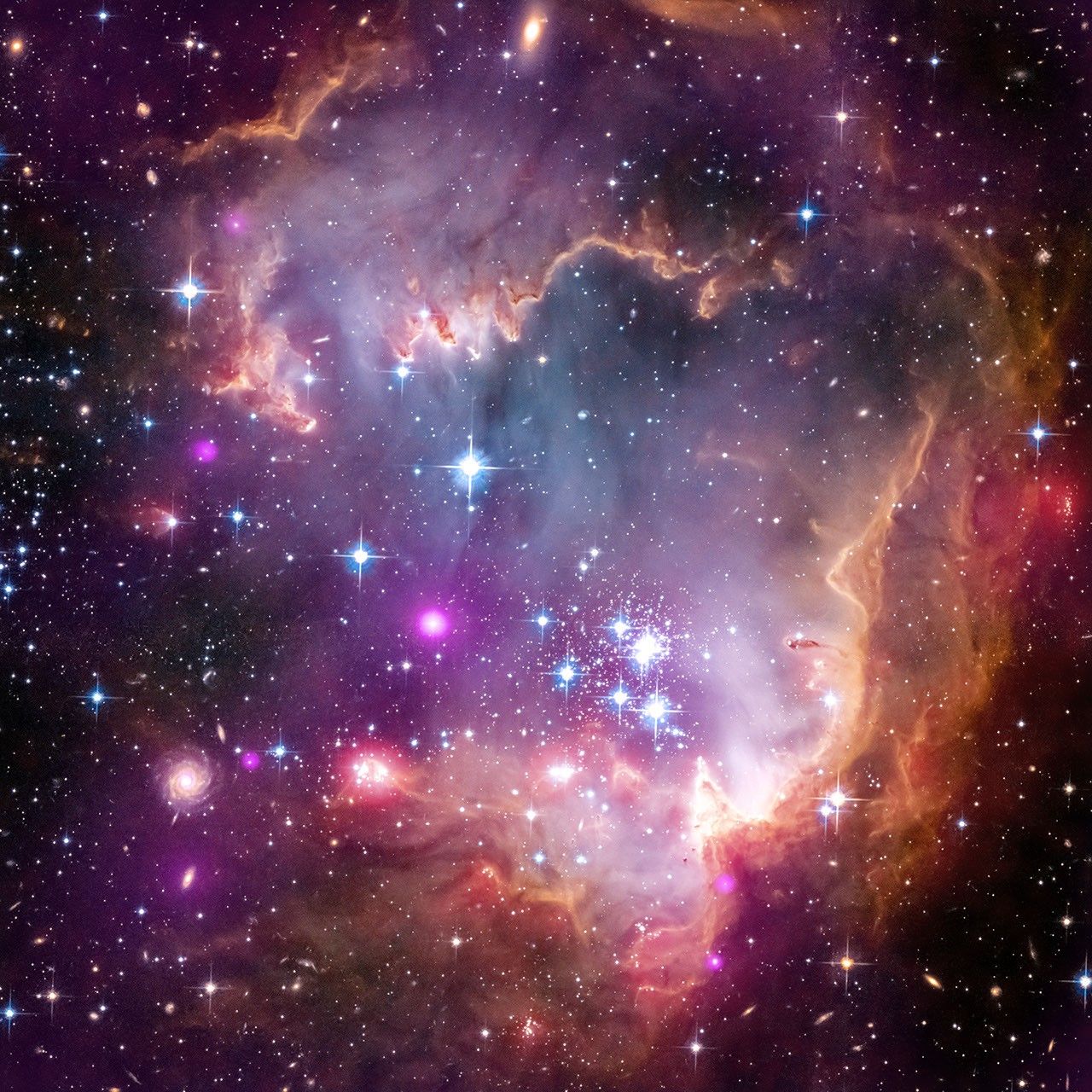 Toward the top, right, and bottom are orange clouds of dust and gas filled with many white, blue, and purple stars. The roughly circular orange clouds look like an open jaw, facing left.