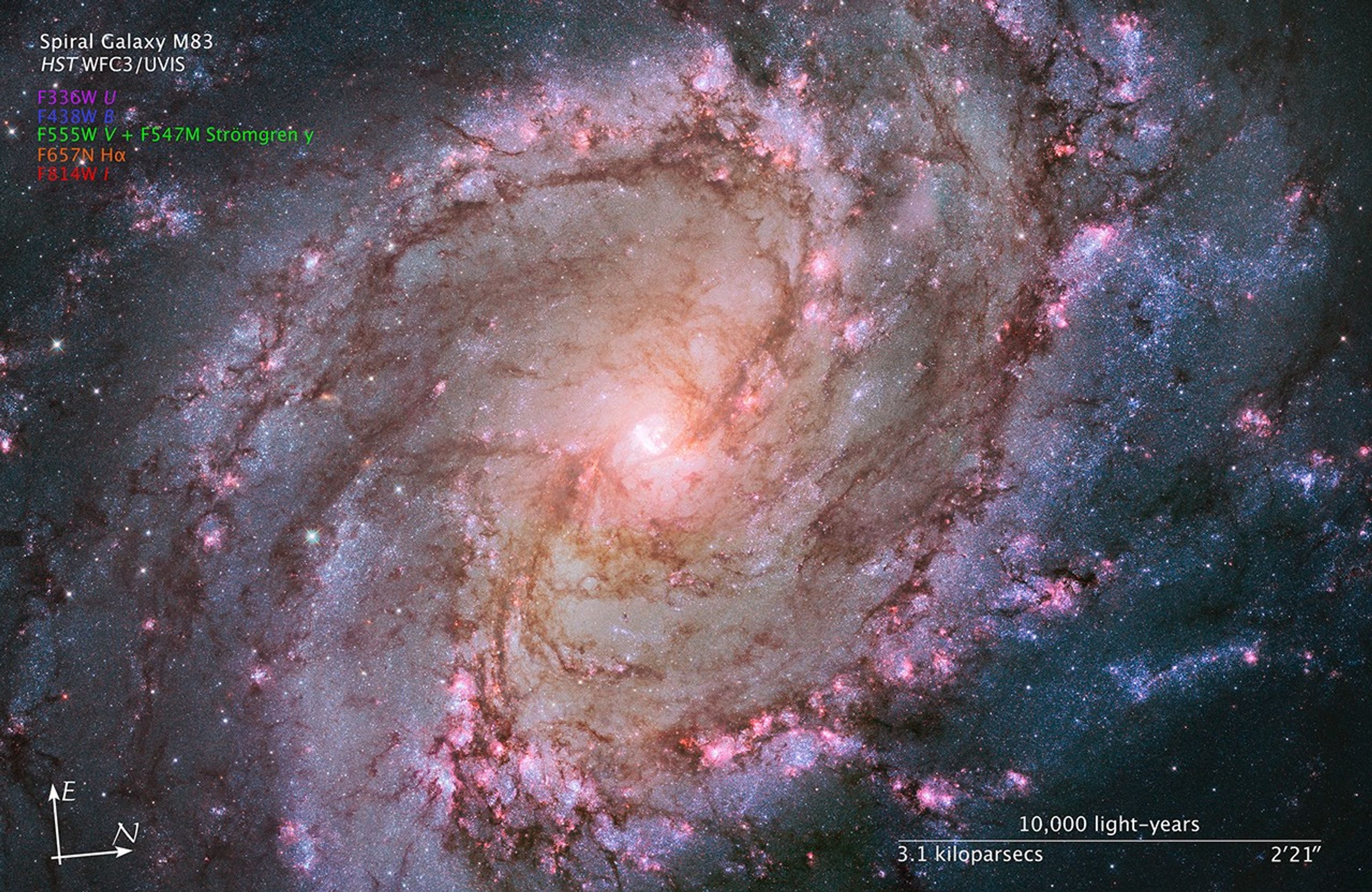Image titled “Spiral Galaxy M83, HST WFC3/UVIS” with compass arrows, scale bar, and color key.