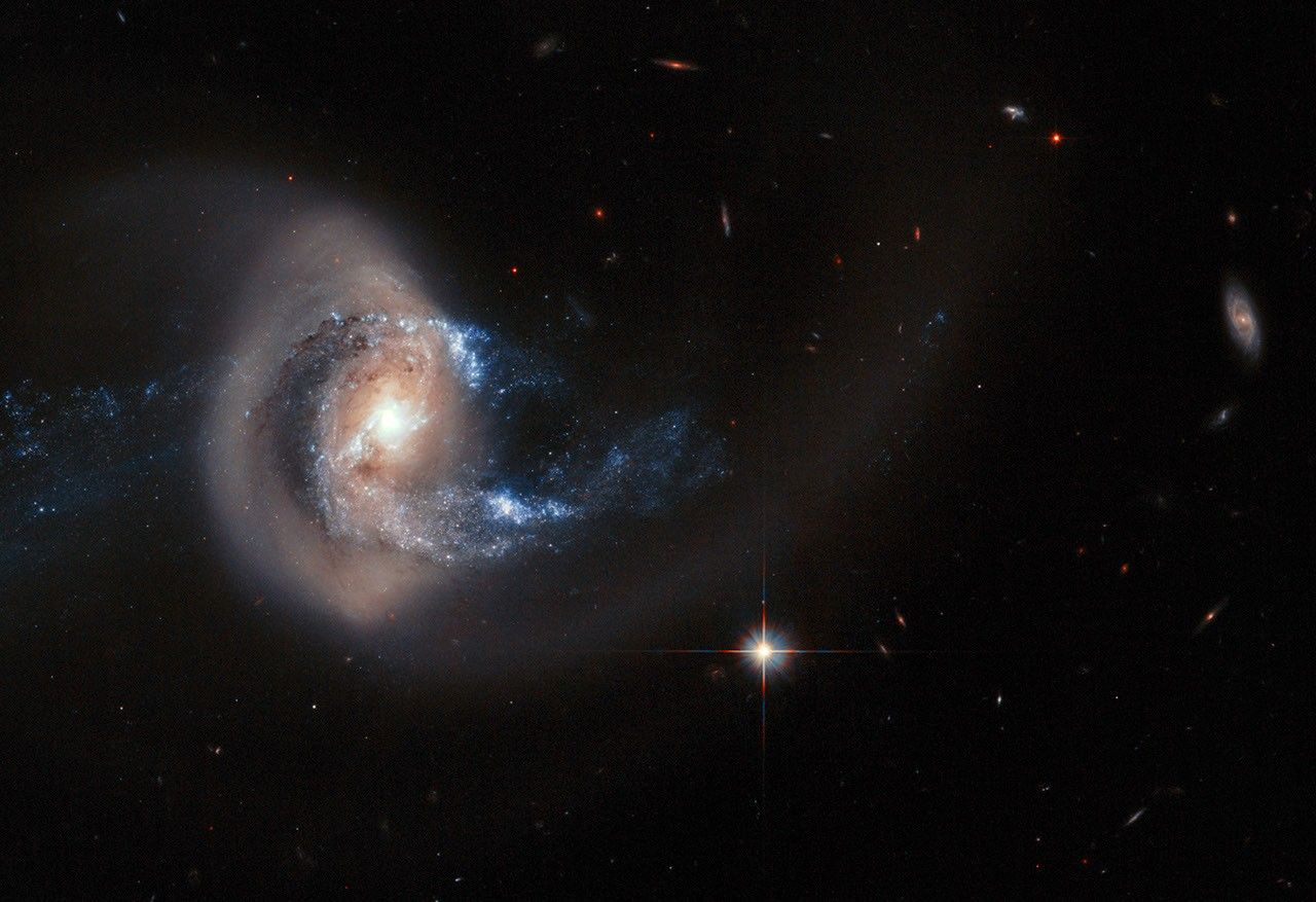 A galaxy in a backward S-shape is offset on the left side of the frame.