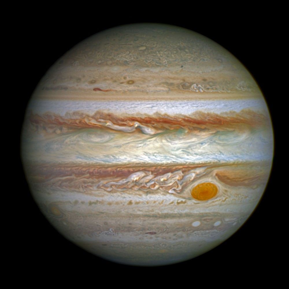 The planet Jupiter. A planet covered in horizontal bands of swirling clouds.