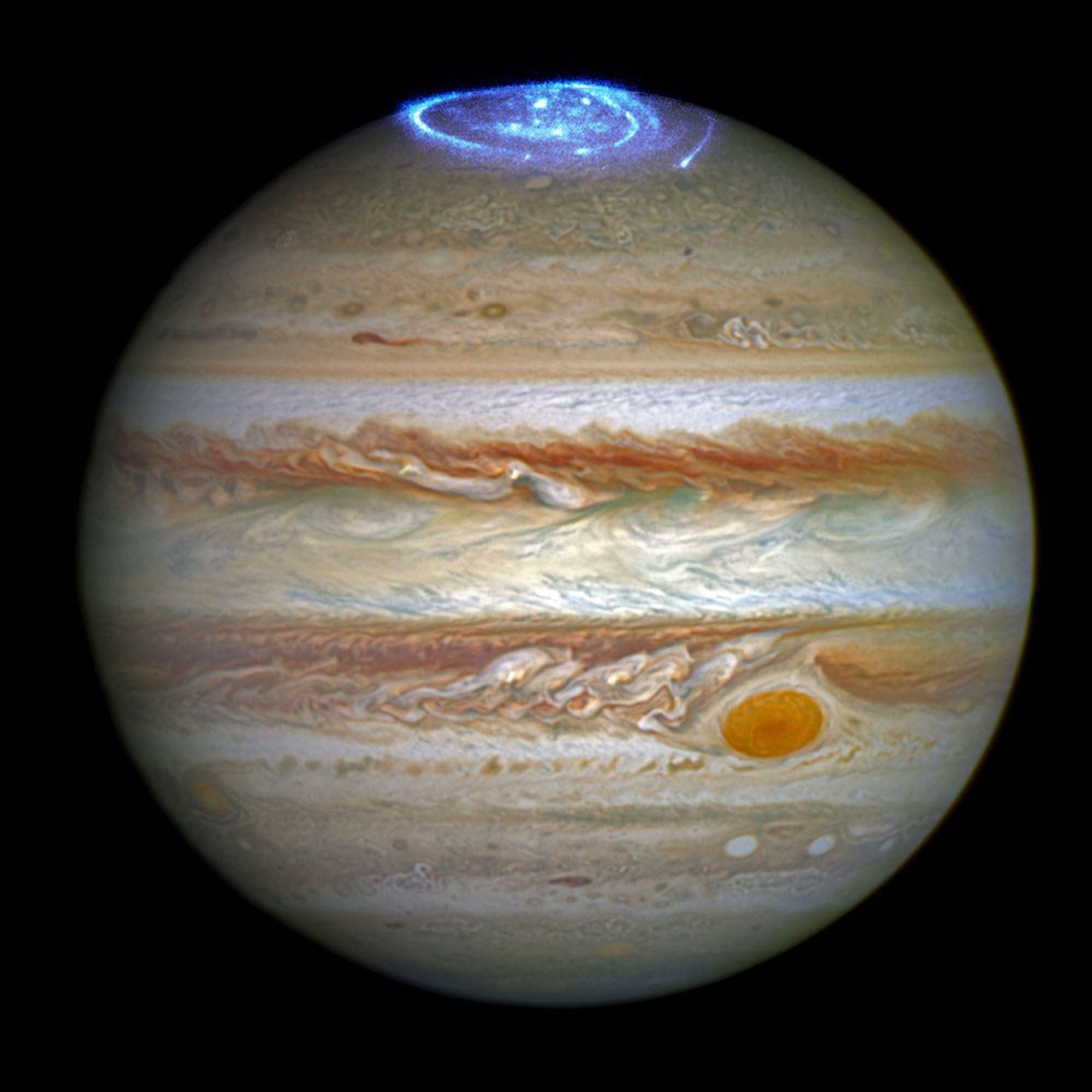 Framed image of the planet Jupiter, a sphere with horizontal stripes of brown, tan, orange, beige, light blue, and white against a solid black background.