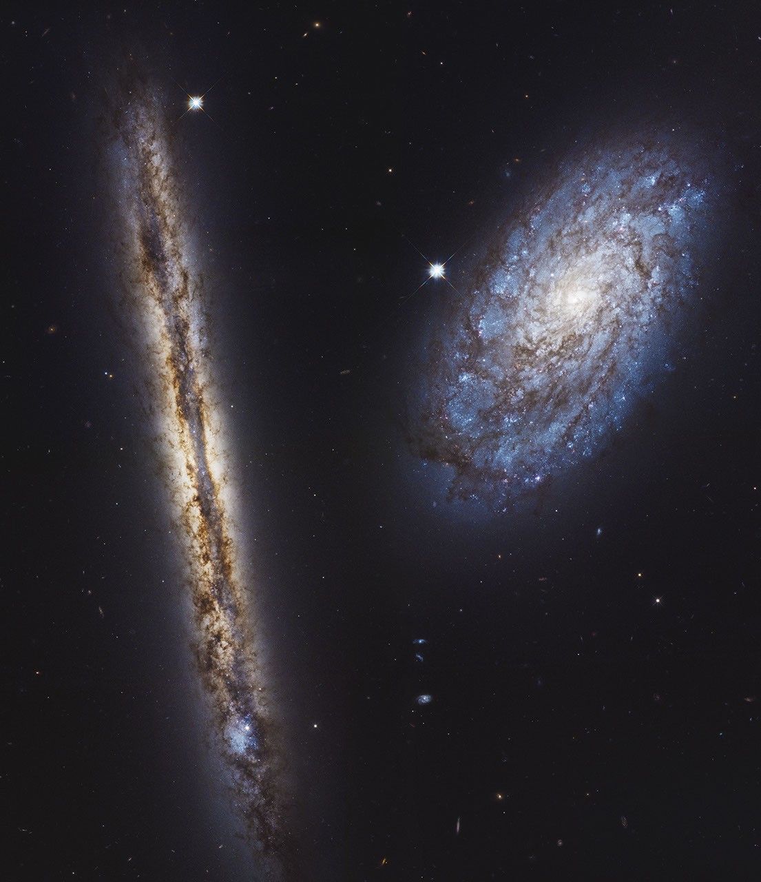 Side-by-side spiral galaxies — one seen edge-on, one almost face-on.