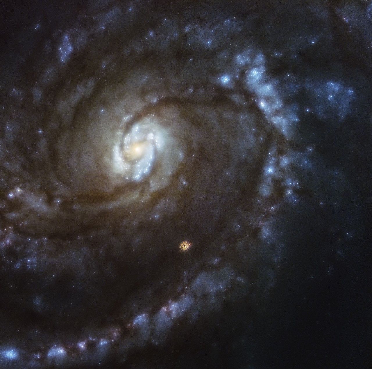 A close-up of spiral galaxy M100 that fills most of the frame. The galaxy is blurry, but general details are visible.