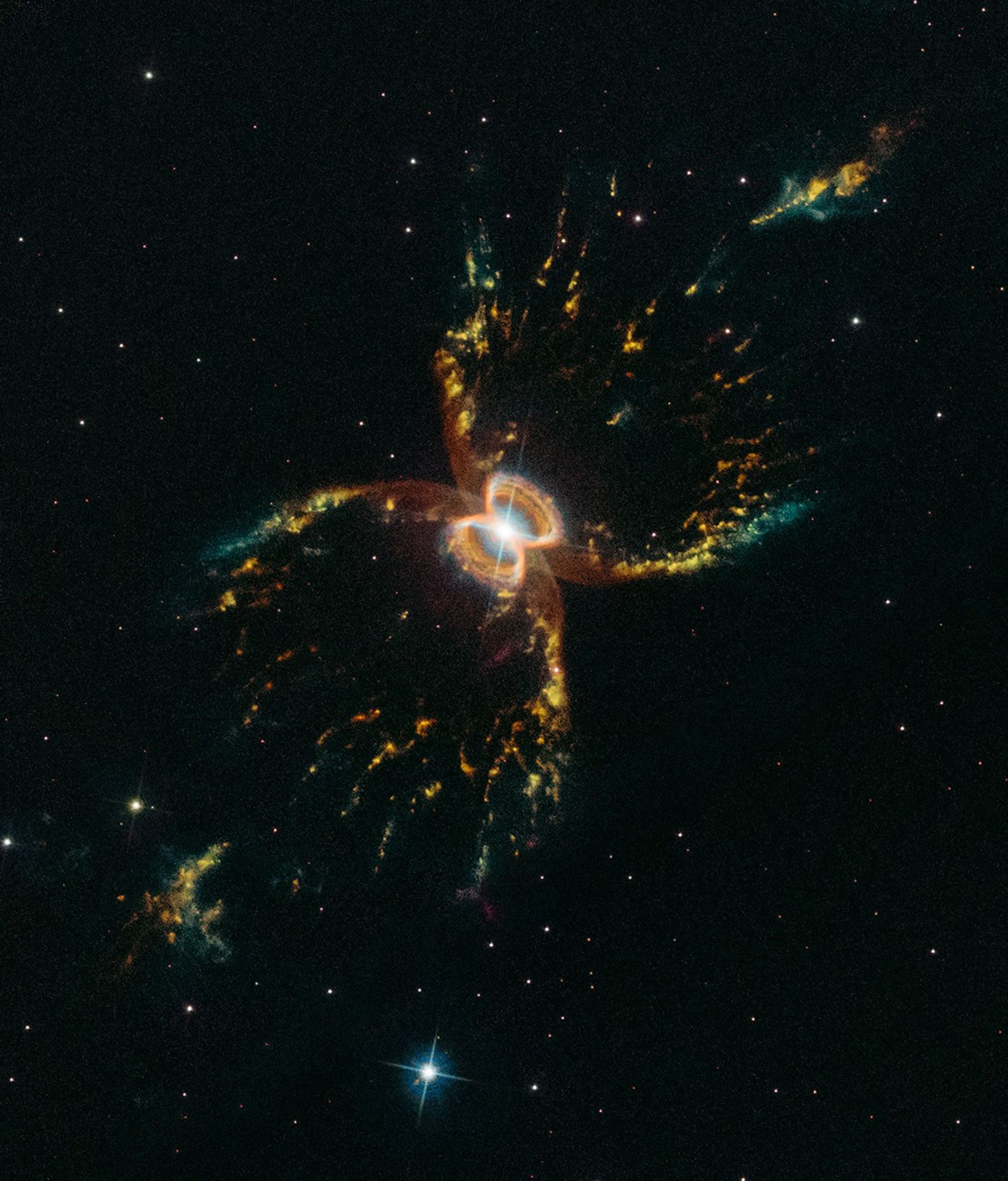 Colorful hourglass-shaped nebula with a bright white star and a glowing figure eight at its center.