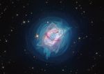 A nebula with a pink elliptical shell is surrounded by concentric rings of blue gas, all set on a black star-filled background.