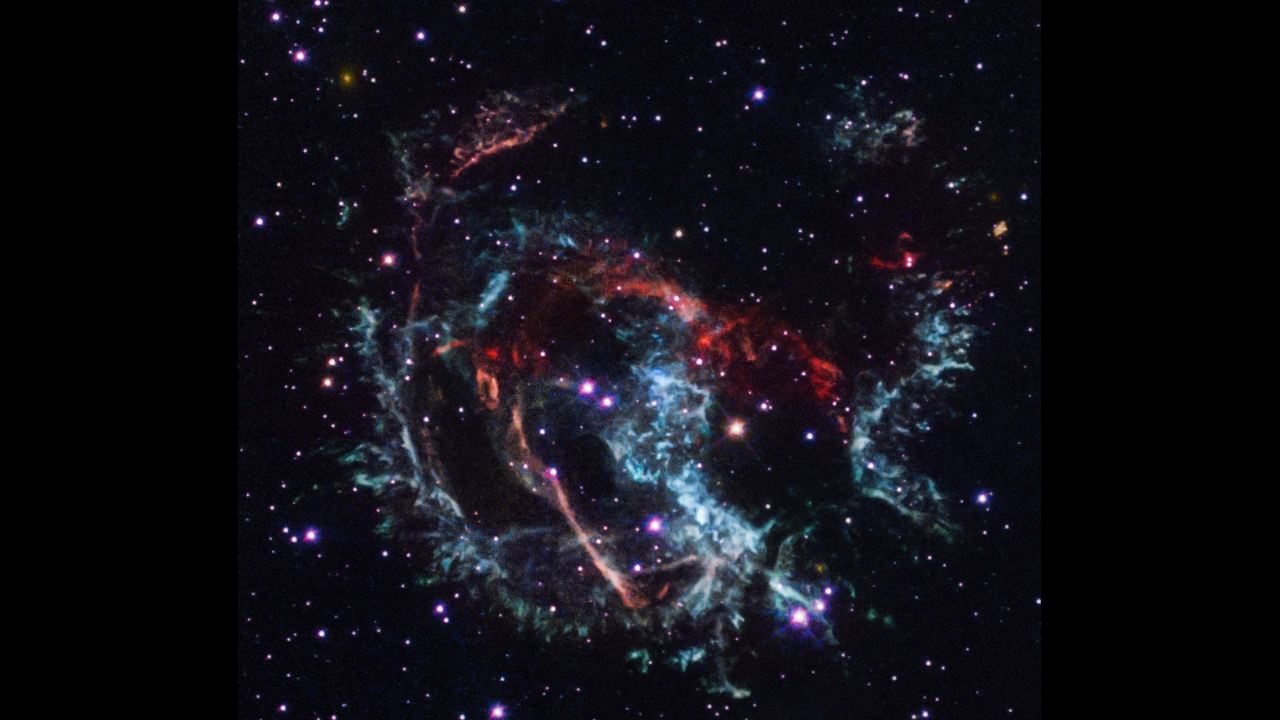 red, green, and blue ribbons of glowing gaseous clumps that make up the supernova remnant.
