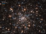 Compass image of globular star cluster NGC 6397 containing blue stars, red giant stars, and a number of small white objects