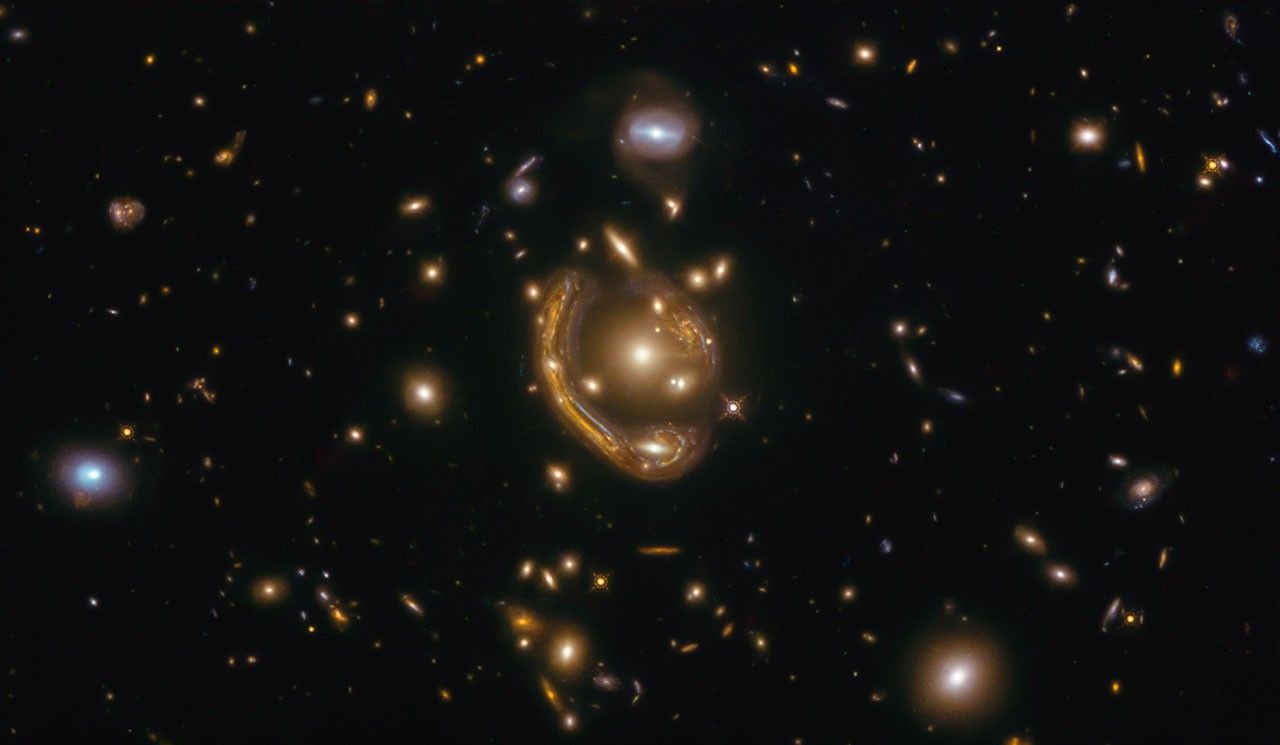 Galaxy curving around its spherical companion, GAL-CLUS-022058s is located in the southern hemisphere constellation Fornax.