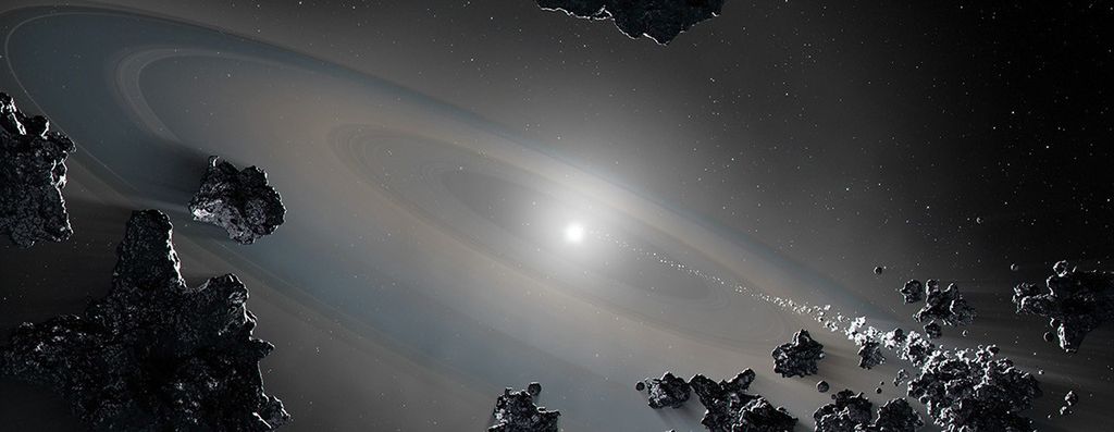 Illustration of a close-up view of the white dwarf system. A tiny star lies at the center, surrounded by a faint disk of material. Rocky-metallic bodies are shown falling into the star.
