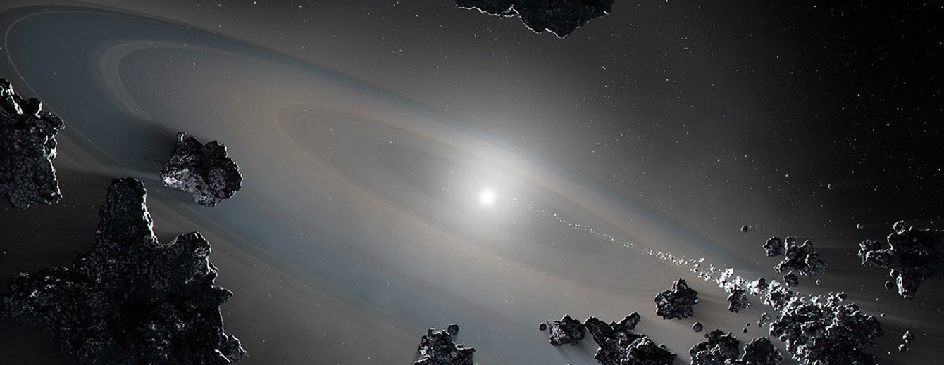 Illustration of a close-up view of the white dwarf system. A tiny star lies at the center, surrounded by a faint disk of material. Rocky-metallic bodies are shown falling into the star.