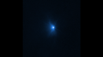On a black background, a bright blue spot is at center. A smoke-like feature starts emitting from the blue spot on the left side, as the asteroid is impacted by the spacecraft.