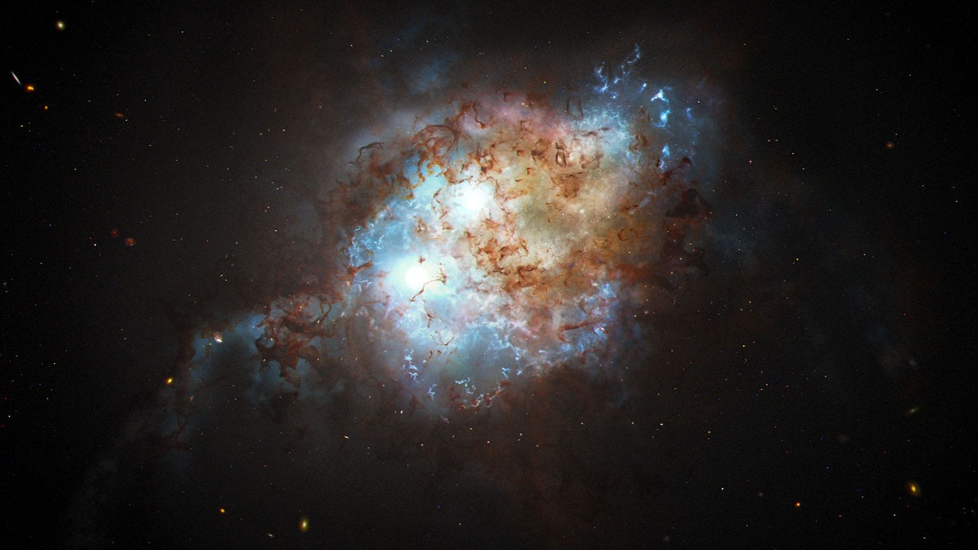 Artist's concept showing a chaotic, nebulous, tangled blur of blue, brown, red, white and gold against a black, deep-space field peppered with stars and galaxies.