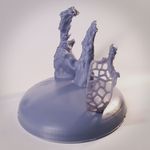 Photograph of a 3D printed model of the Pillars of Creation. The model is light gray with a silk-like texture, and the background is white.