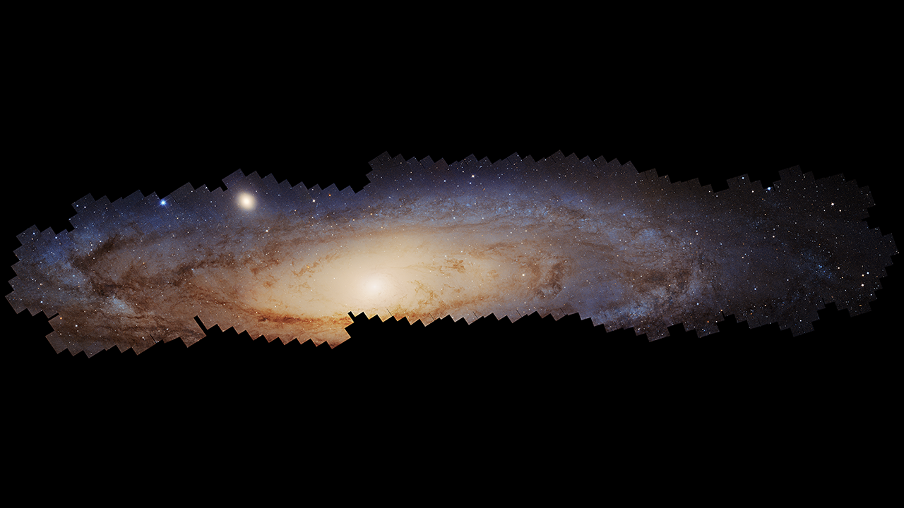 This video opens with the largest photomosaic ever assembled from Hubble Space Telescope observations. It is a panoramic view of the neighboring Andromeda galaxy, located 2.5 million light-years away. The spiral disk galaxy is inclined to our view, making it look elliptical. Young blue stars are around the outer rim. Yellowish older stars are toward the center. The bright hub of the galaxy looks like the center of a fried egg. It took over 10 years to make this vast and colorful portrait of the galaxy, requiring over 600 Hubble snapshots. This stunning mosaic captures the glow of 200 million stars. The camera zooms into the central portion of the galaxy, resolving a sea of myriad older stars. The camera pans along the galaxy's vast disk which is over 200,000 light-years across. The view is etched with dark dust clouds. The stellar population looks bluer as we move toward the galaxy's outer rim, rich in bright blue star clusters.