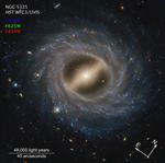 Image titled u201cNGC 5335, HST WFC3/UVISu201d at top left with compass arrows and color key at the bottom. Below the name, filters are listed: F475W in blue, F625W in green, and F814W in red. These colors indicate the visible-light color is assigned to each filter. Barred spiral galaxy NGC 5335 takes up the majority of the view. At its center is a milky yellow, flattened oval surrounded by what looks like a bar extending from top left to bottom right. Around this is a thick swath of blue stars speckled with white regions. Multiple arms wrap up and around in a counterclockwise direction. Distant galaxies in an array of colors are speckled throughout the black background. The length of the scale bar at bottom left is about a quarter of the total width. It is labeled 48,000 light-years and 45 arcseconds. At the bottom right are compass arrows indicating the orientation of the image on the sky. The east arrow points toward 10 ou2019clock. The north arrow points toward 2 ou2019clock.