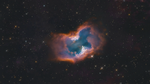 NGC 2899 set against the black background of space. The planetary nebula is shaped like a single macaroni noodle, with its edges pointed up, but its edge-on central torus is semi-transparent in the middle.