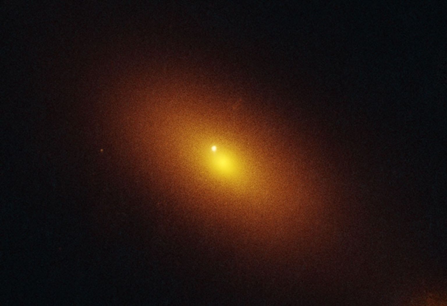 A red circle encompasses a galaxy in a snapshot of an all-sky survey.