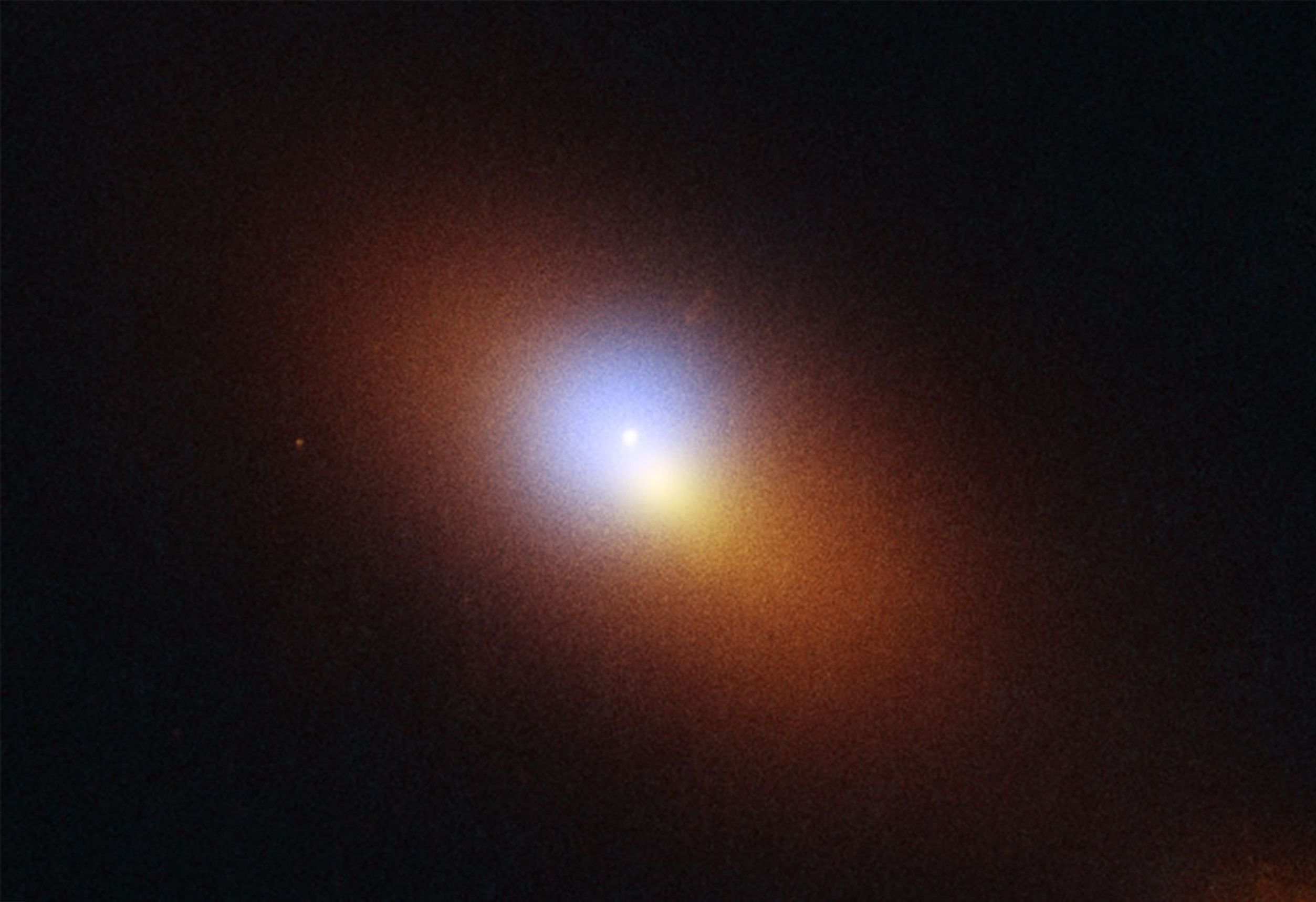 This is a combined Hubble Space Telescope/ Chandra X-Ray Observatory image of distant galaxy that is host to the telltale signature of a roaming supermassive black hole. Both telescopes caught a tidal disruption event (TDE), an intense flash of radiation caused by the supermassive black hole eating a star. The TDE appears as an isolated blue-white point source of ultraviolet light, while the galaxy is colored orange in visible light. In addition, X-Ray light is captured by Chandra as a purple haze surround the TDE. Both Hubble and Chandra observations were combined to pinpoint the TDE’s location, which is offset from the center of the galaxy, which appears as a bright orange-white blob.