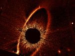 A grainy orange oval ring tilts slightly from upper right to lower left.