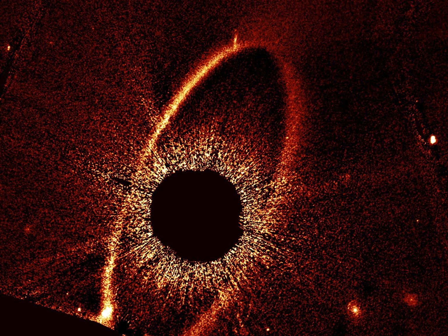 A grainy orange oval ring tilts slightly from upper right to lower left.