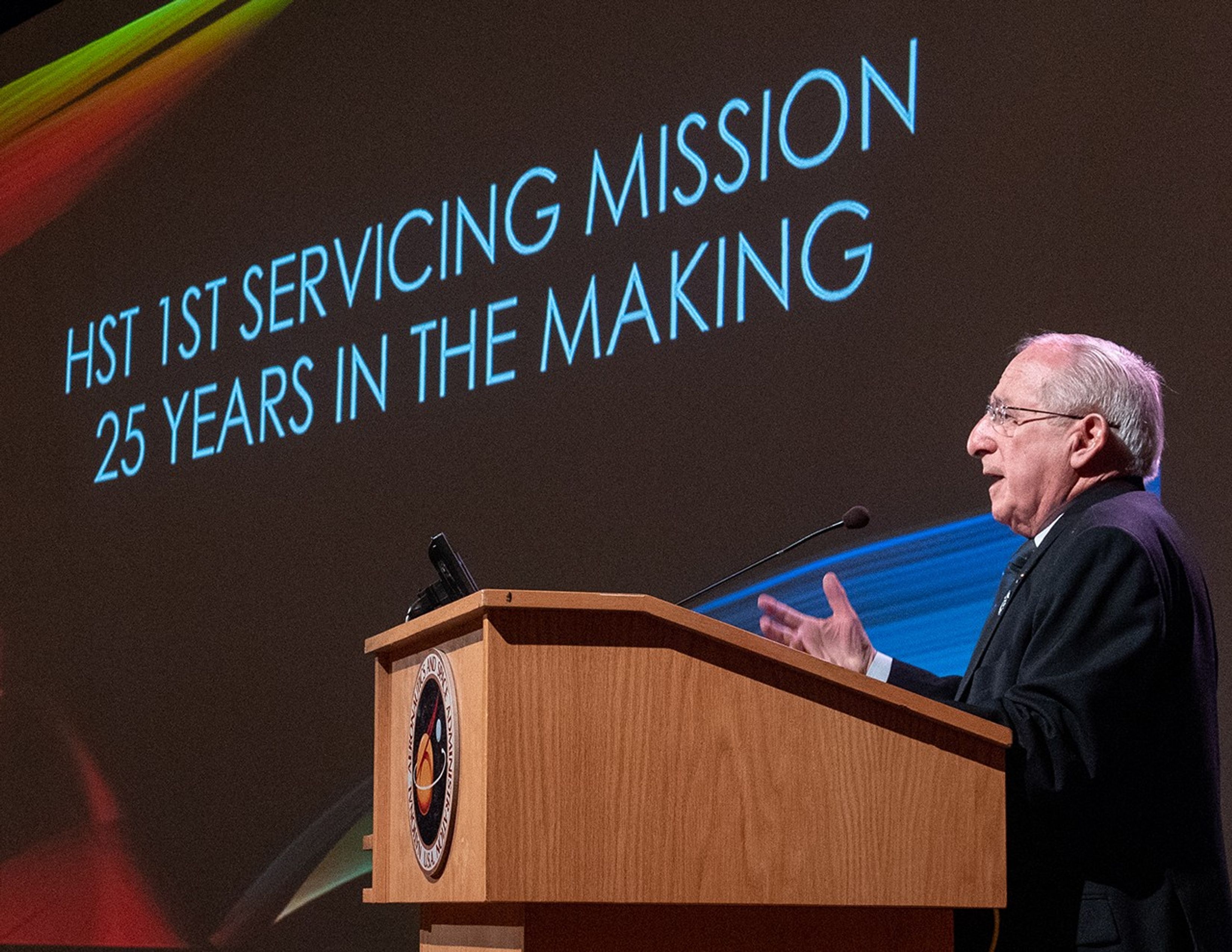 Joseph Rothenberg stands at the podium, addressing the audience.
