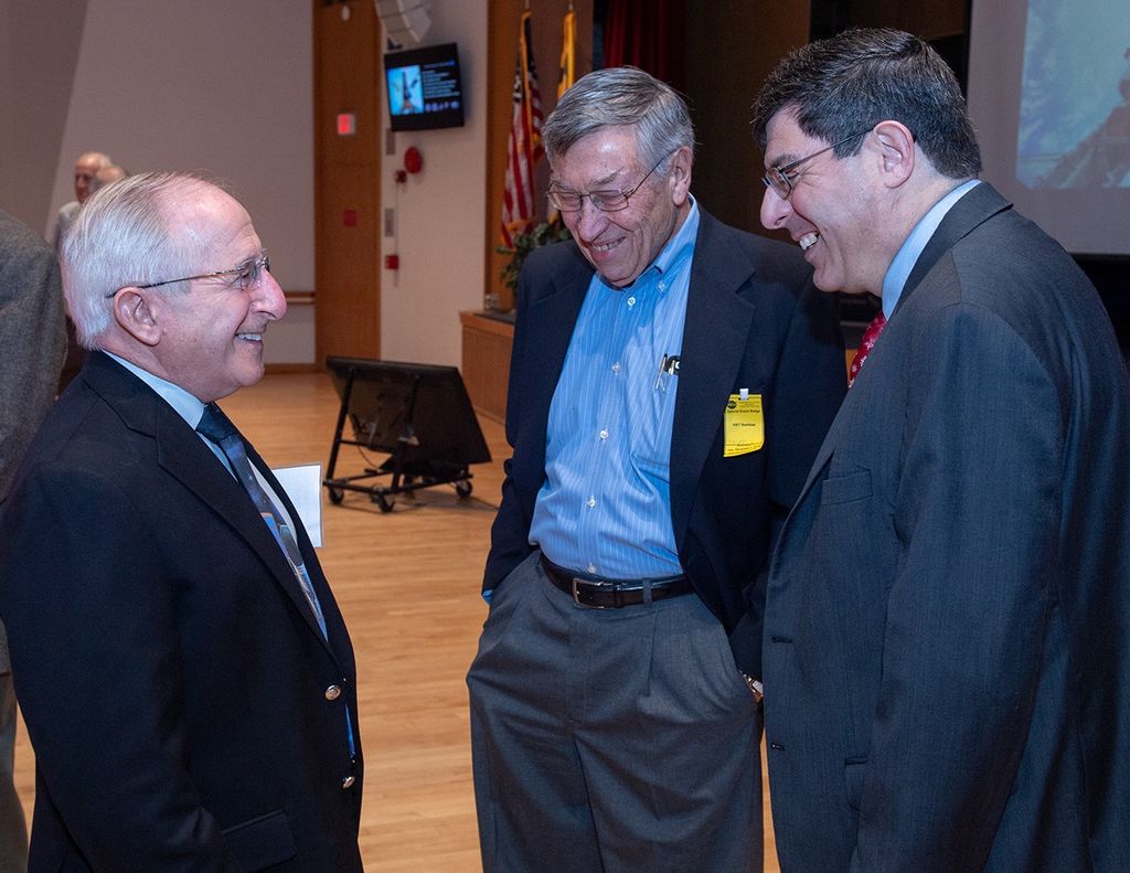 Three men stand talking: Joseph Rothenberg (left), Vernon Weyers (center) and Christopher Scolese (right).