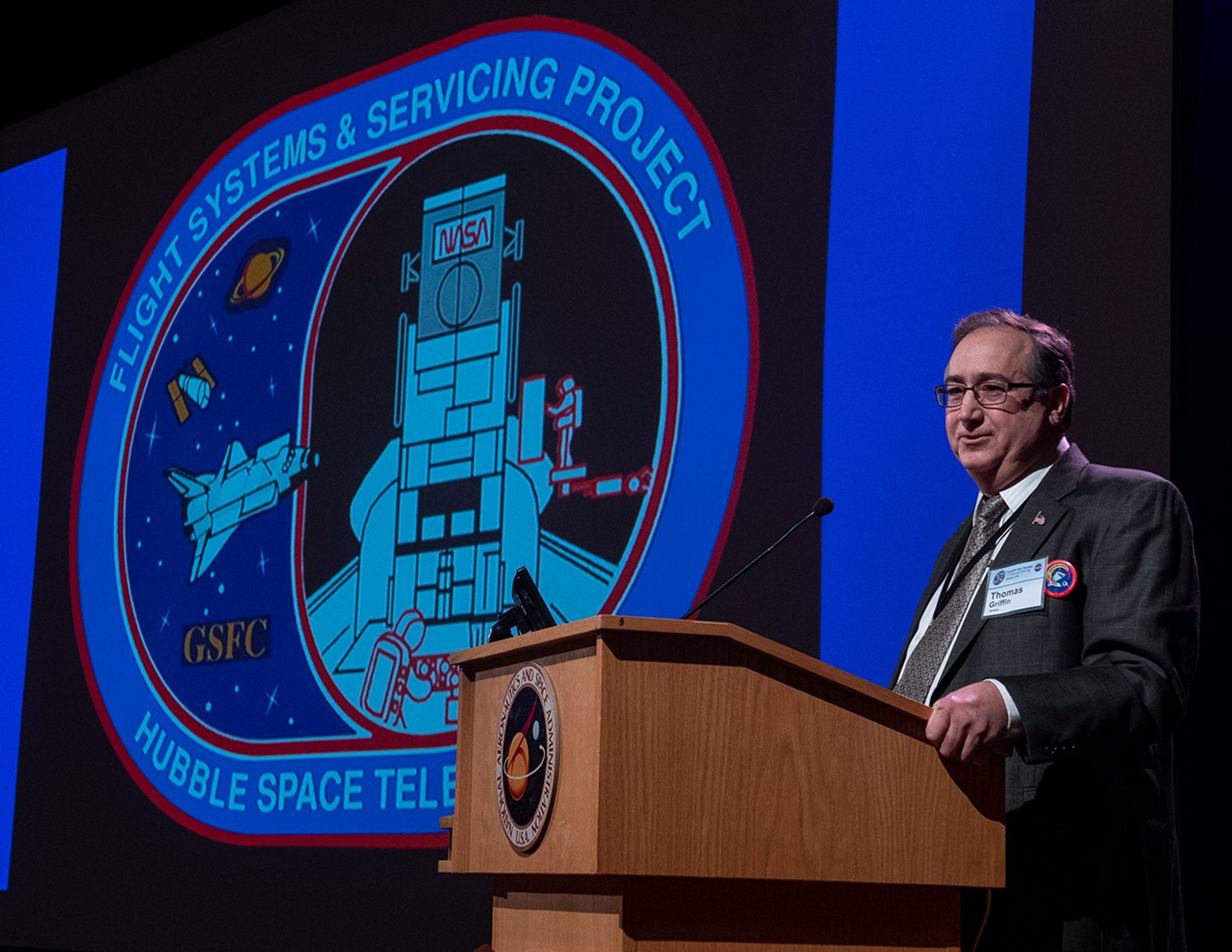 Thomas Griffin stands at the podium, addressing the audience.