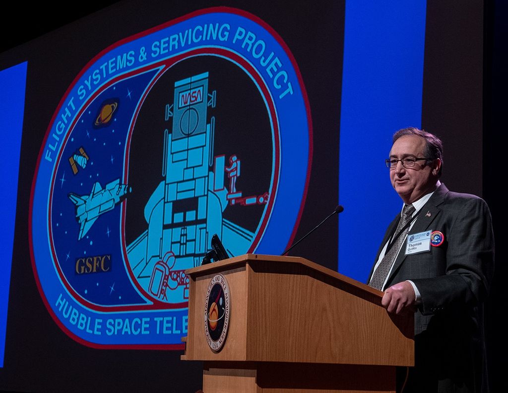 Thomas Griffin stands at the podium, addressing the audience.