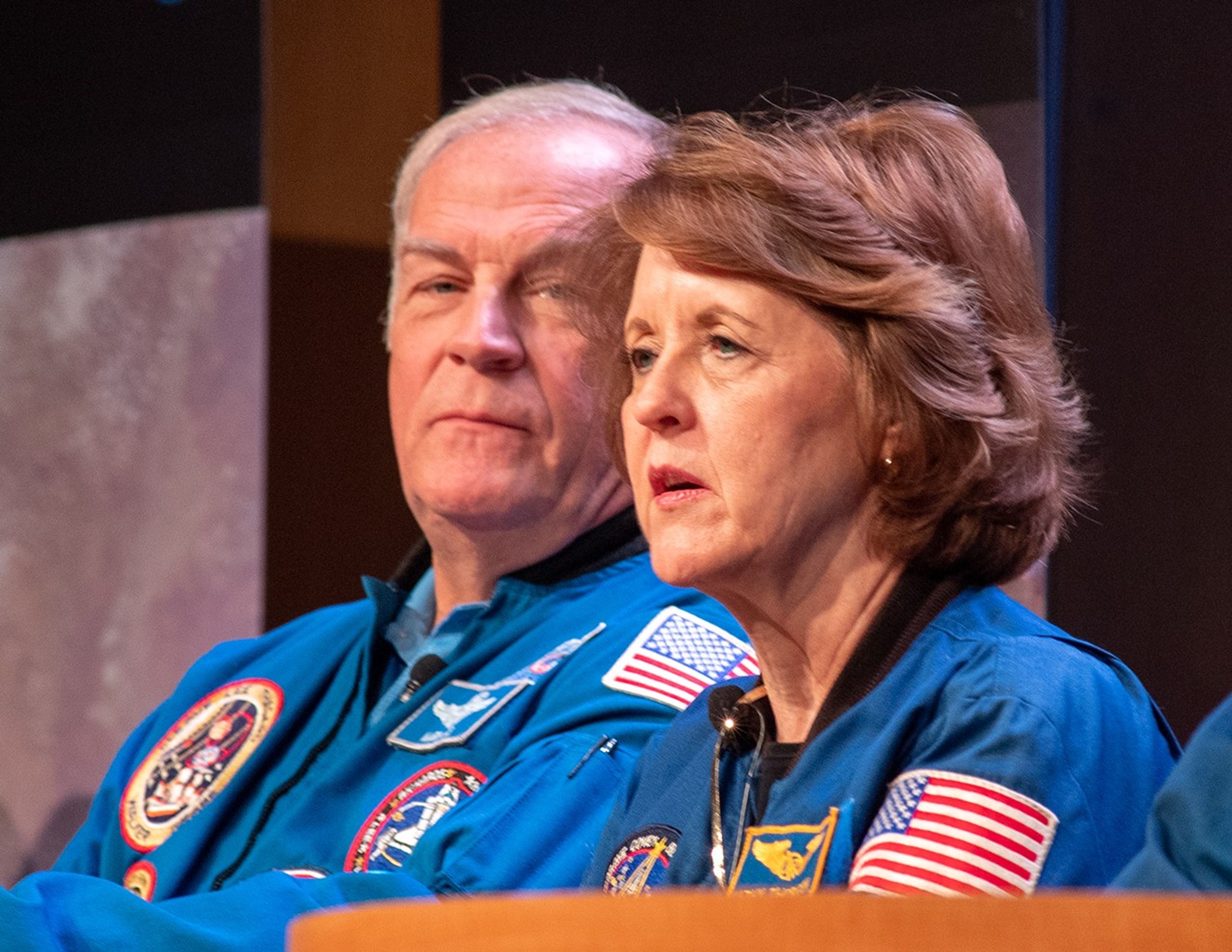 Kathy Thornton (right) speaks to the audience while Mark Lee (left) listens.