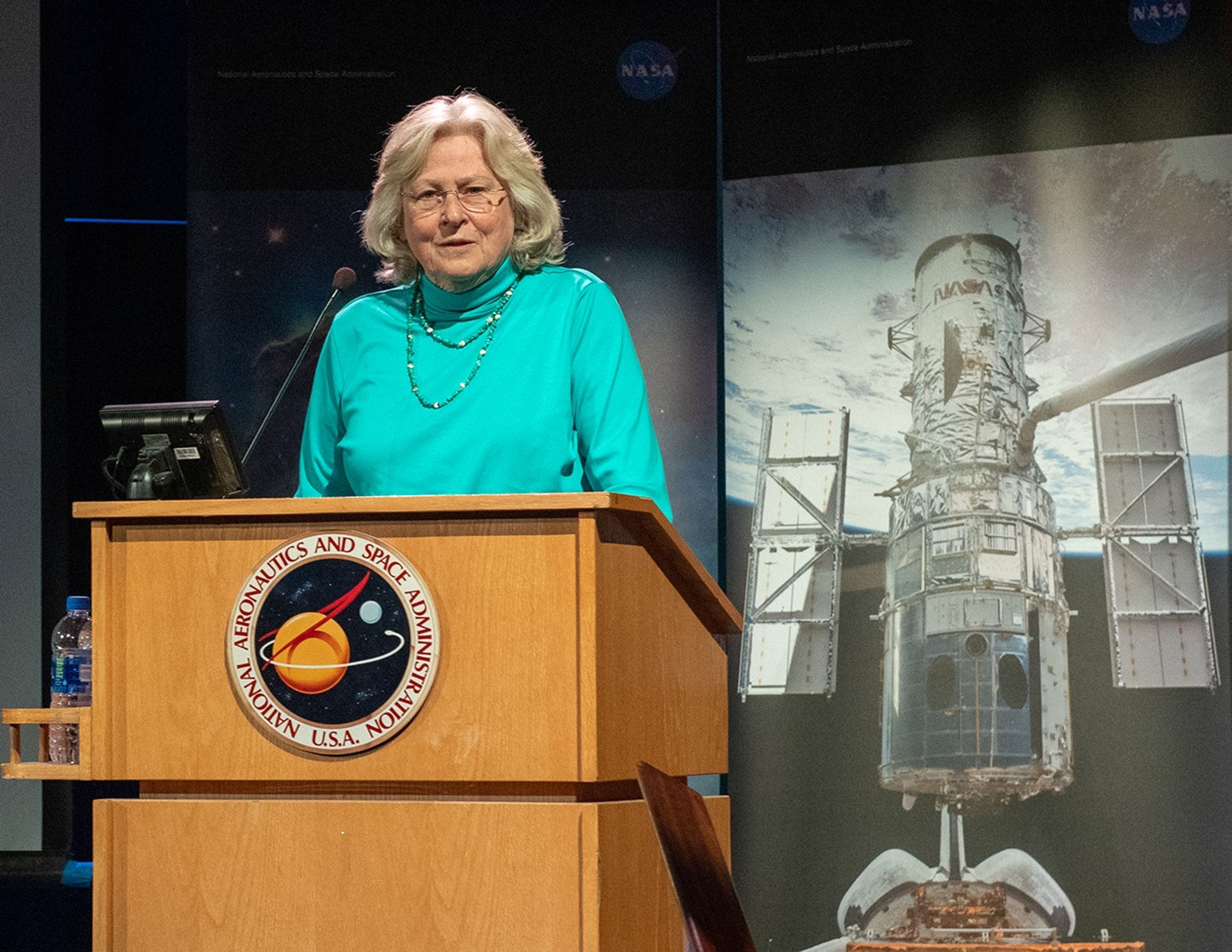 Sara Heap speaks from the NASA podium.