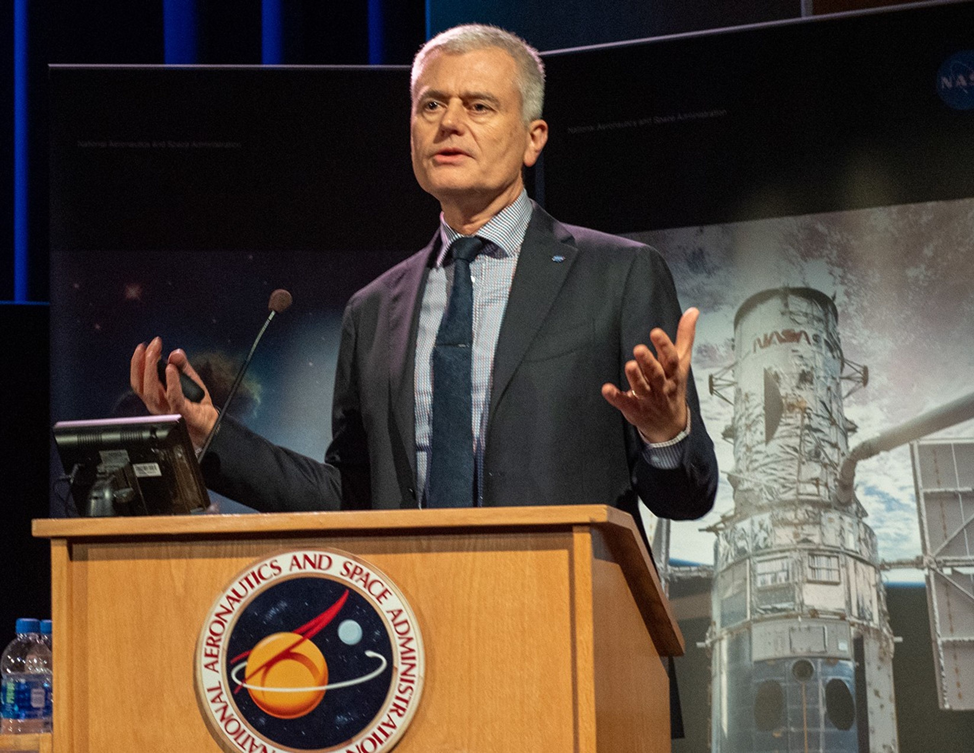 Mark Clampin speaks from the NASA podium.