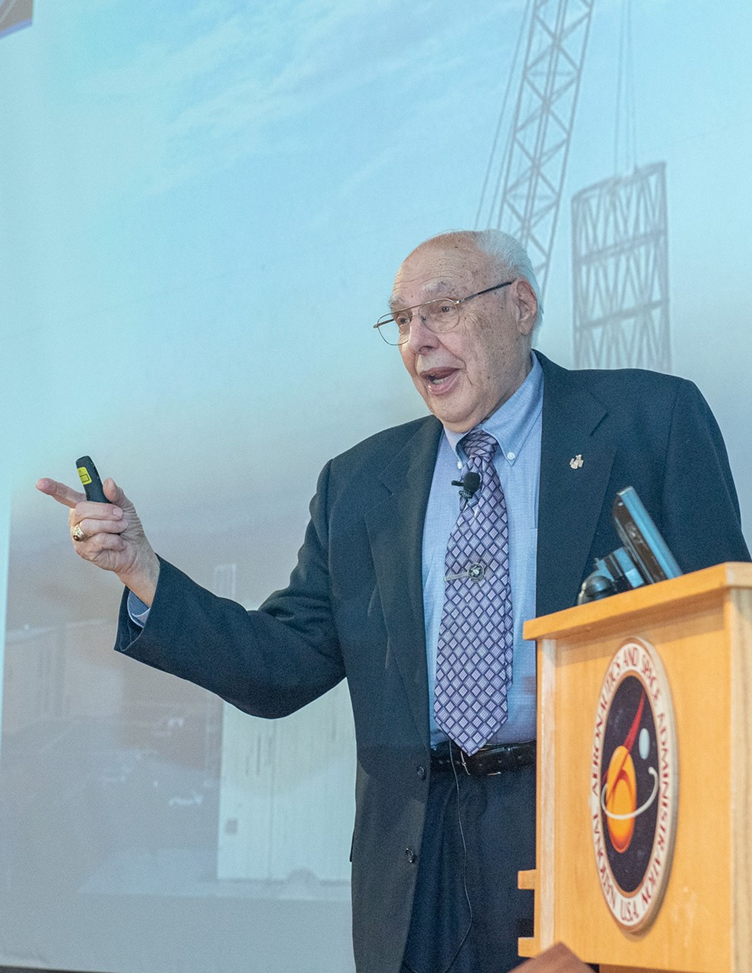 Frank Cepollina speaks while standing by the NASA podium.