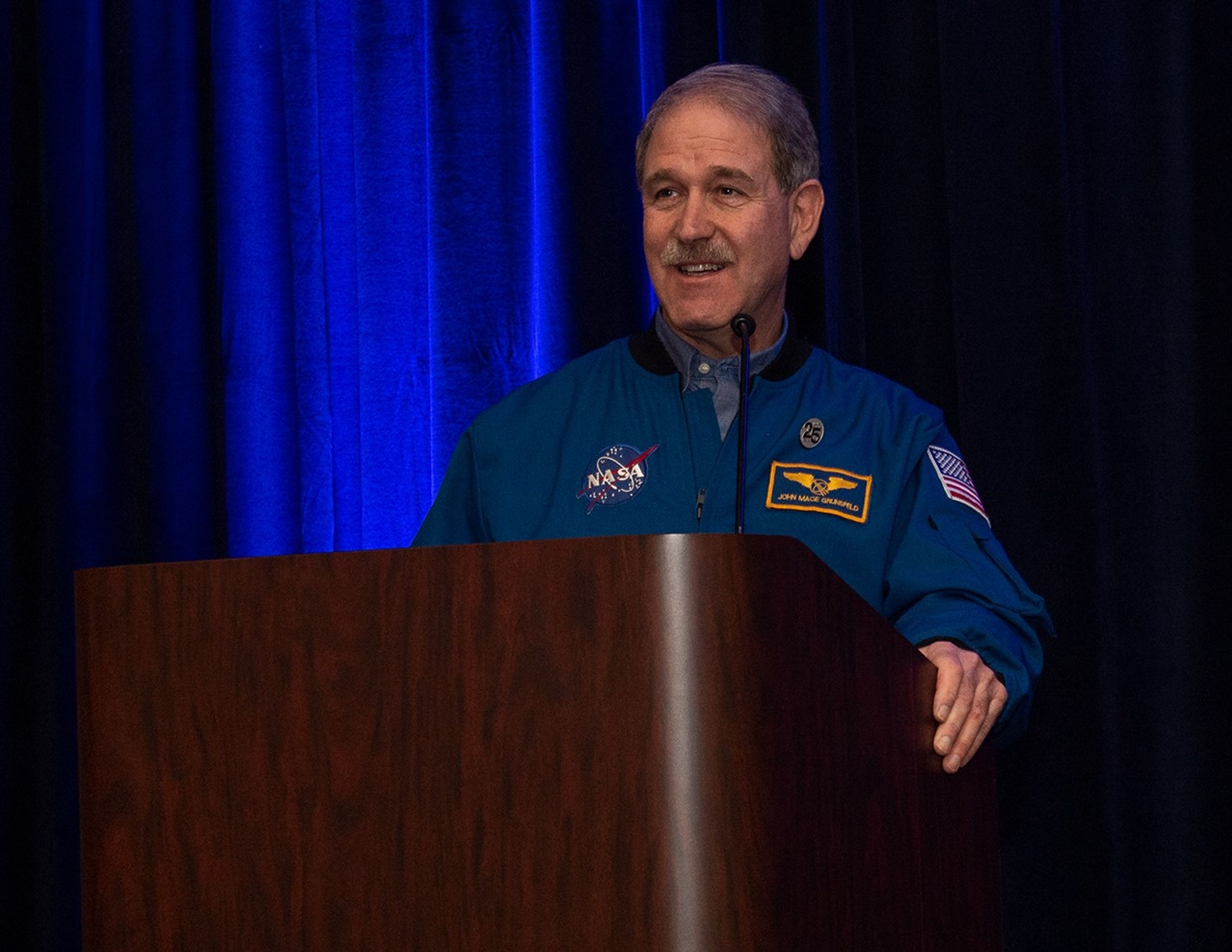 John Grunsfeld speaks from the podium.