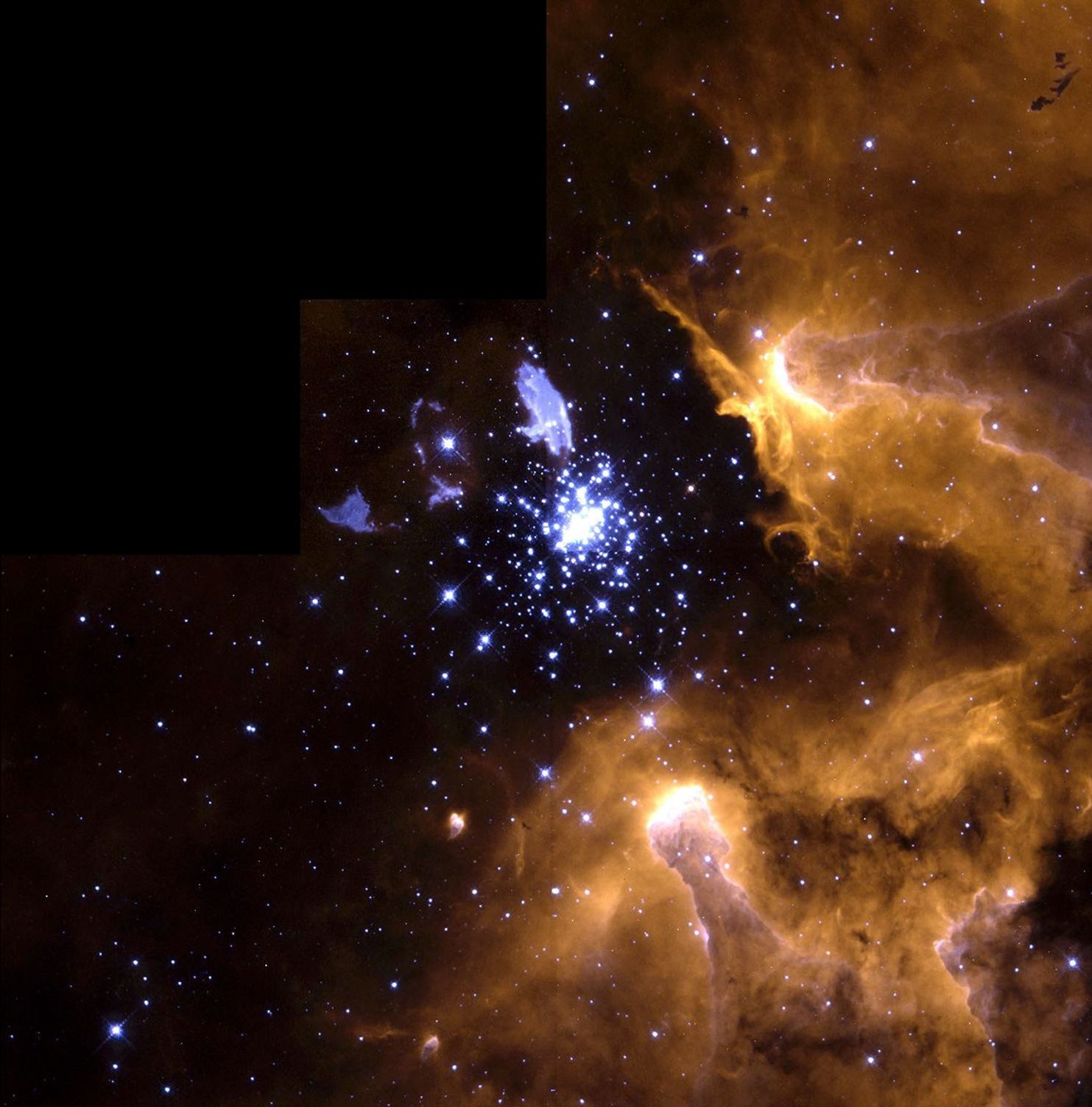 Large cluster of blue stars in the center of the image, surrounded by yellow-orange and pink dust and gas.