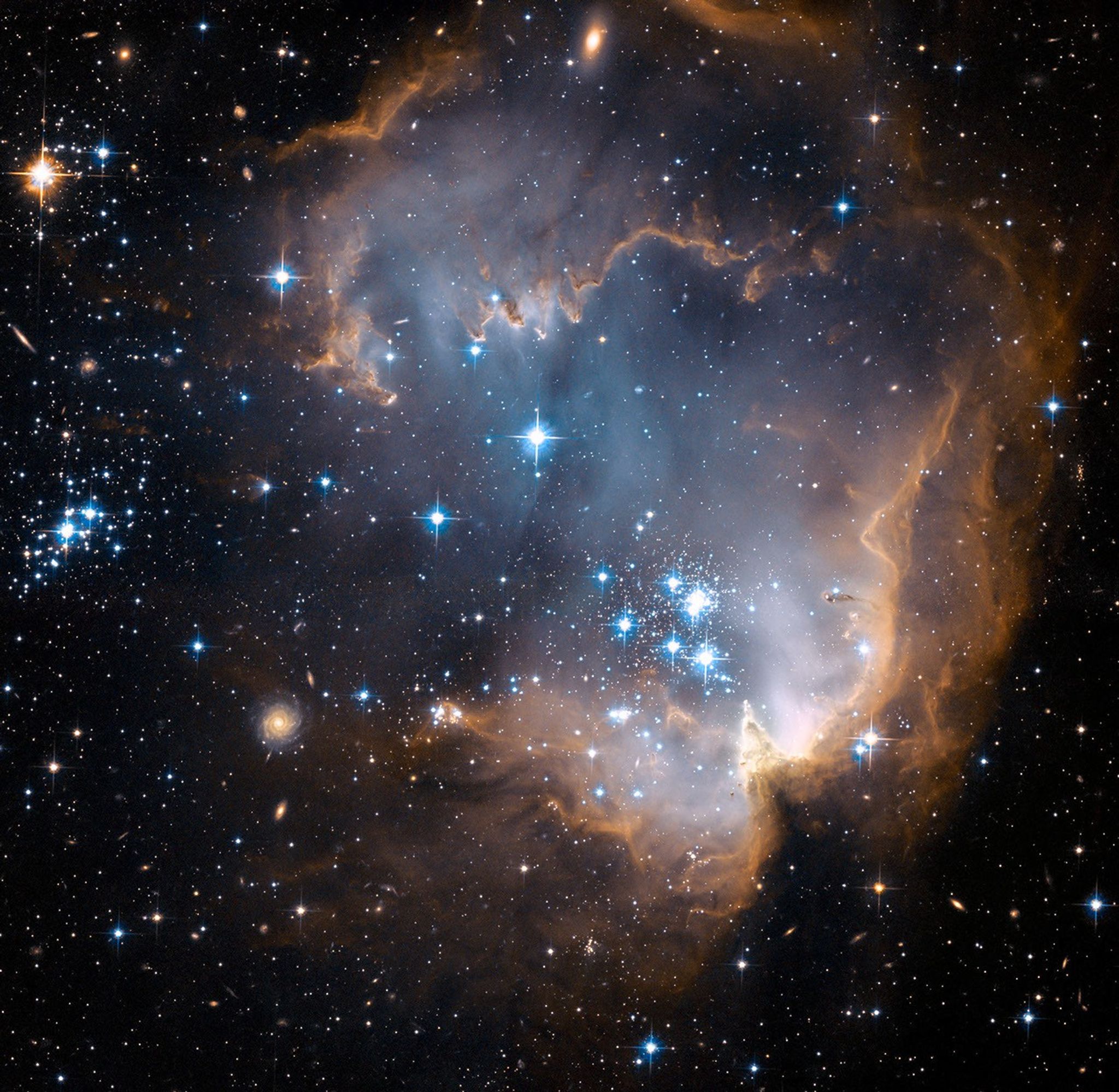 Blue-white clouds fill the scene. The top, right, and lower-right hold rusty-brown, dark clouds. These clouds billow out along the top and bottom of the image in an elongated backwards "C." Bright stars dot the scene.