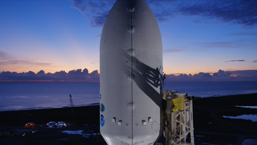 Image shows the sunrise in the background with a white spacecraft in the foreground at NASA's Kennedy Space Center in Florida on Wednesday, Sept. 24, 2025. NASA and SpaceX are preparing to launch IMAP and its rideshares