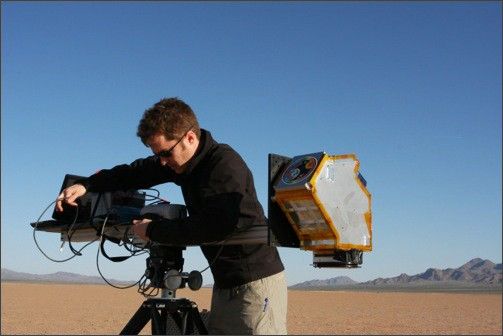 Photo of Joel McCorkel, an LDCM Science Team member and SOLARIS scientist, with the tripod-mounted SOLARIS in the field to collect data in concert with the LDCM under-flight of Landsat-7.