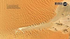 A Landsat scene of the bright tan Namib Desert.