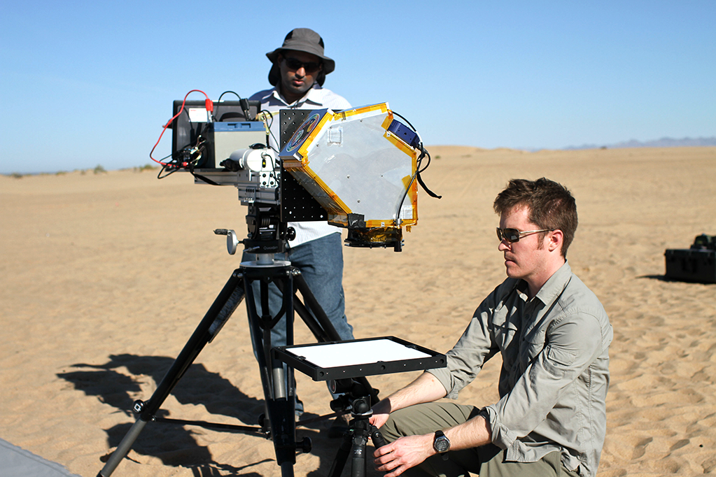 Landsat calibration scientist Joel McCorkel (right) and analyst Amit Angal take a calibration panel measurement with the SOLARIS (Solar, Lunar for Absolute Reflectance Imaging Spectroradiometer) instrument in California’s Algodones Dunes.