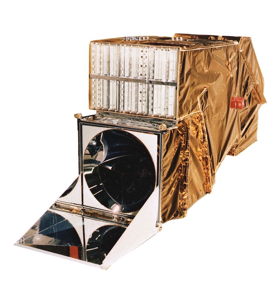 Physical model of the Thematic Mapper instrument showing its gold thermal blanket covering, mirror assembly, and internal detector components used for imaging the Earth.