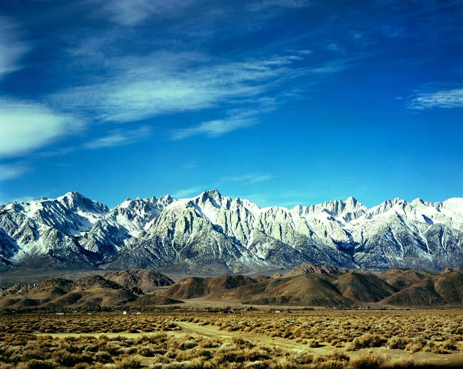 Landsat 5 Thematic Mapper image showing snow-capped mountains bordering Death Valley with desert scrubland in the foreground.