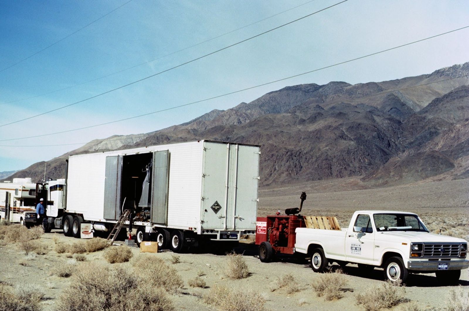 Mobile ground station trailer carrying Landsat 5 TM equipment during field operations in desert mountainous terrain.
