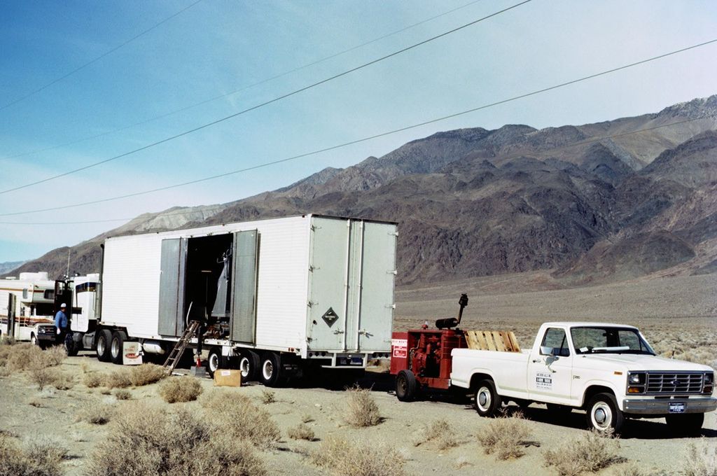 Mobile ground station trailer carrying Landsat 5 TM equipment during field operations in desert mountainous terrain.