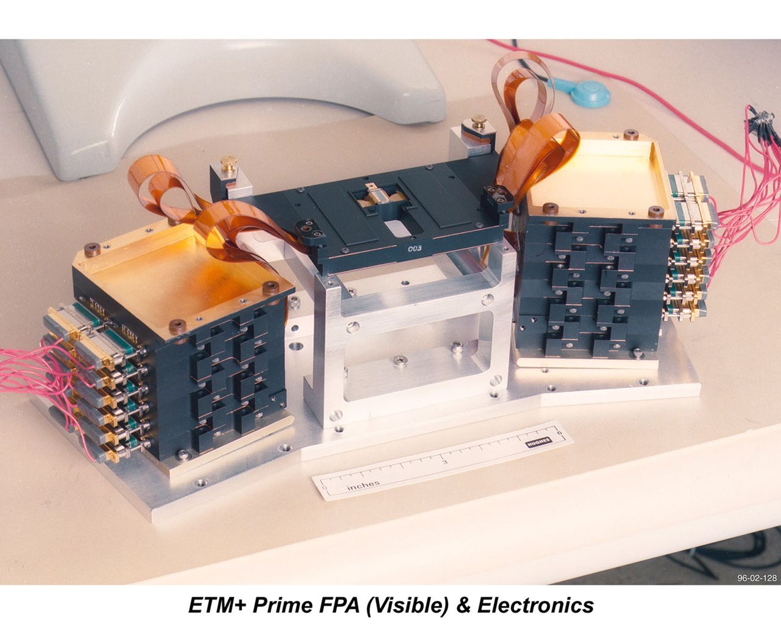 Landsat 7's ETM+ Prime Focal Plane Array (Visible) and supporting electronics during testing and integration, showing the interconnected modules that process Earth observation imagery data.