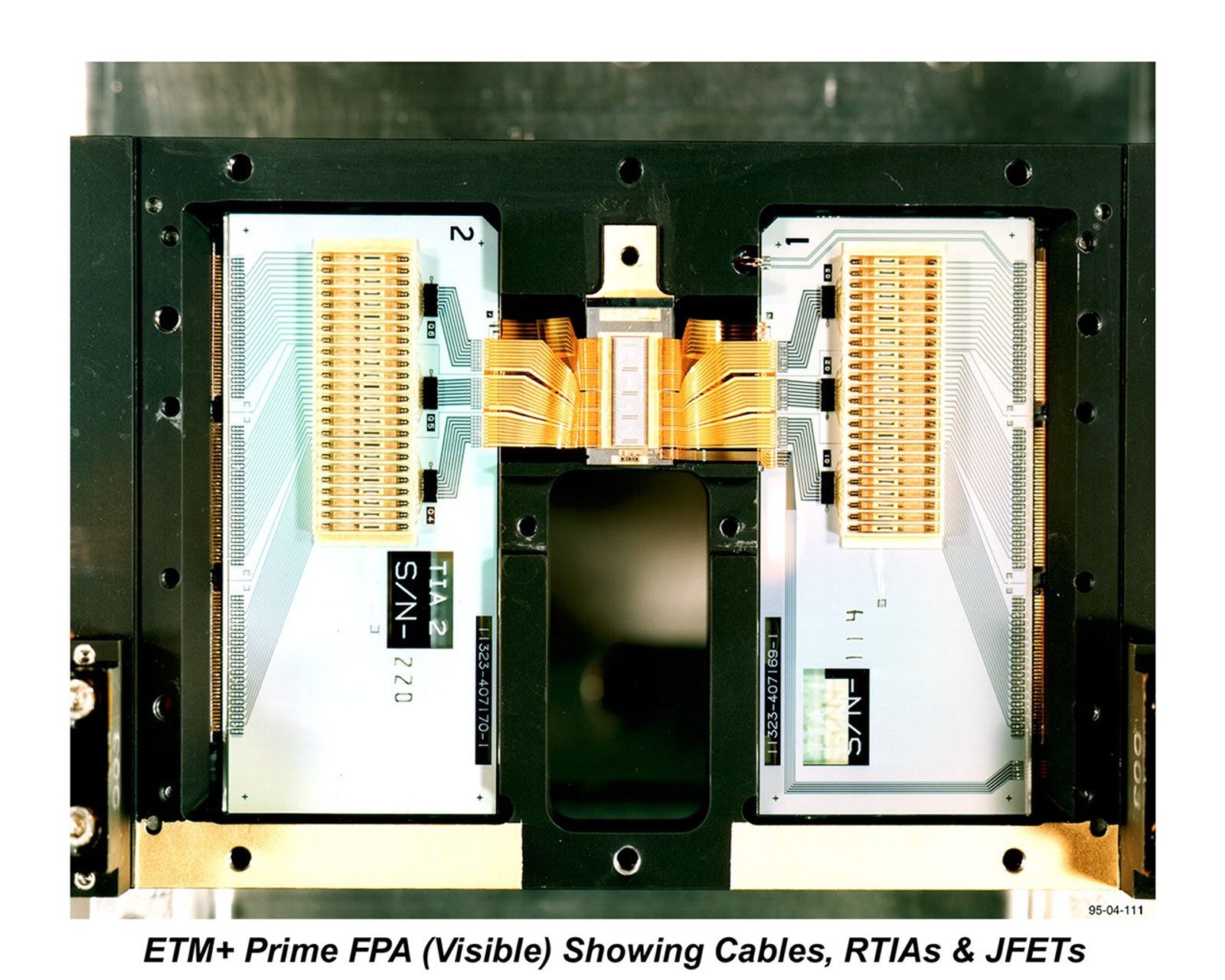 Landsat 7's Enhanced Thematic Mapper Plus (ETM+) Visible Focal Plane Array during assembly and testing. This precision electronic component contains the detectors responsible for capturing visible wavelength imagery of Earth's surface.